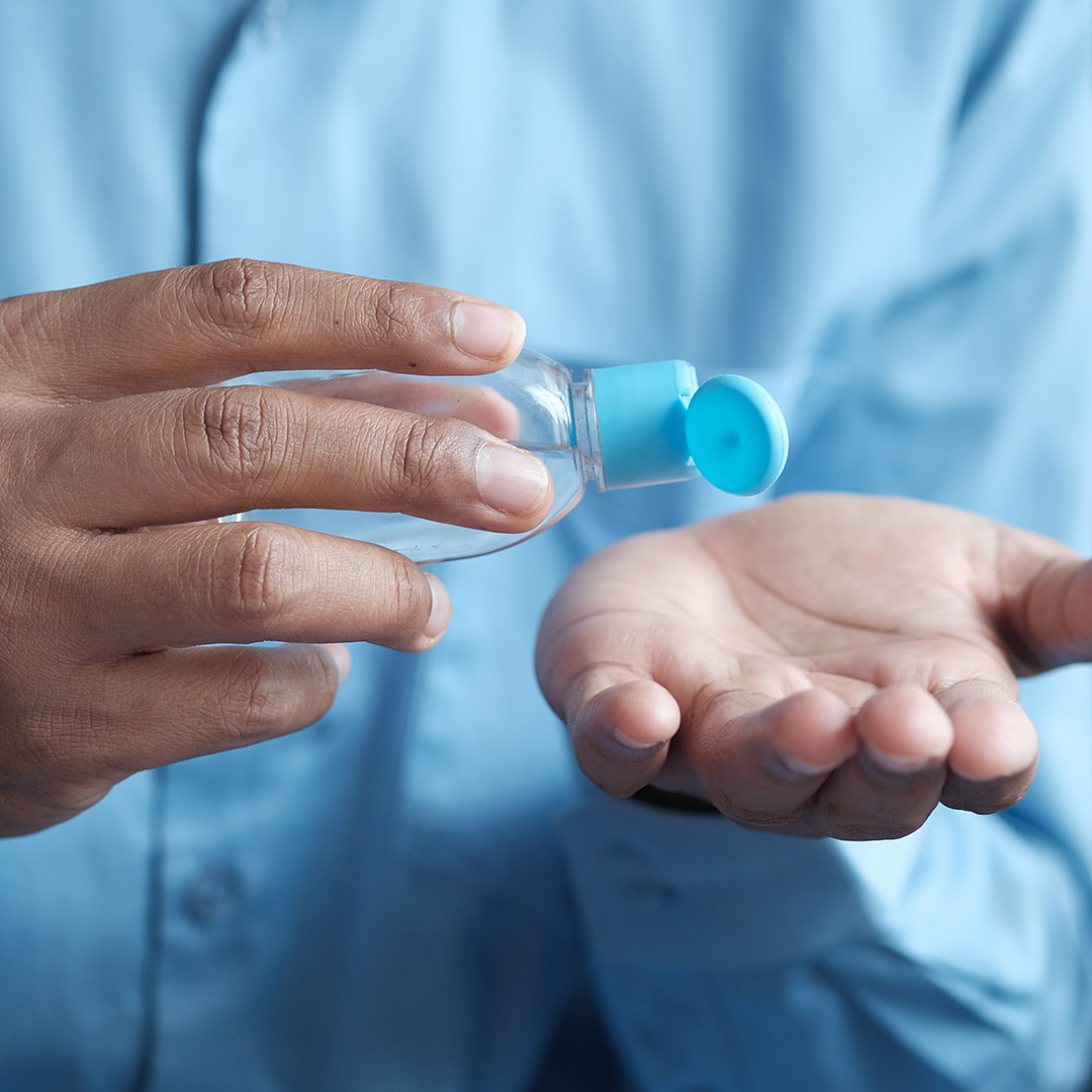 Person pouring hand sanitizing on hand